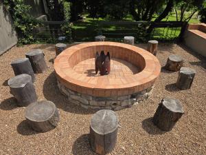 a dog is sitting in a brick fire pit at Merino Guest Farm in Clarens