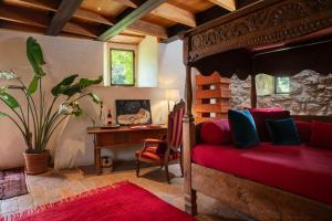 a bedroom with a bed and a desk and a table at Castello Di Vicarello in Sasso dʼOmbrone