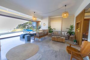 a living room with a couch and a table at Villa Almy in Plaka +40 photos