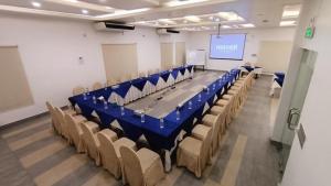 a conference room with a long table and chairs at Nascent Gardenia Residence in Dhaka