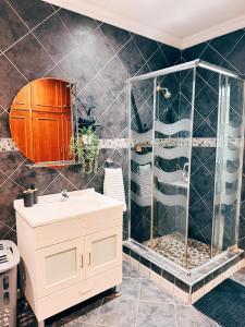 a bathroom with a sink and a shower at Peach Blossom Guesthouse in Welkom
