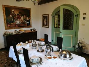 a dining room with a table with a white table cloth at Casa Due Tigli B&B in Corno di Rosazzo