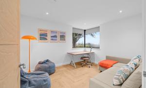 a living room with a couch and a desk at An Teallach in Balmullo +41 photos