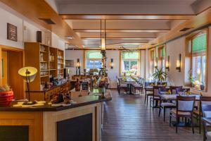 a restaurant with a bar and tables and chairs at Der Bayerische Hof in Grünbach