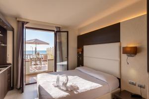 a bedroom with a bed with a view of the beach at Del Prado in Riva Ligure