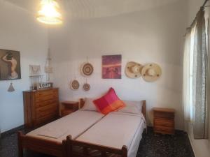 a bedroom with a bed and a dresser at Panorama Georgia's house in Áyios Vasílios