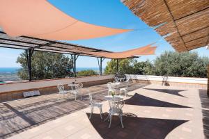 a patio with tables and chairs on a roof at La Fiesta House in Capaccio-Paestum