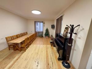 a dining room with a table and a christmas tree at Ashtarak Garden GuestHouse in Ashtarak