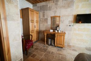 a corner of a room with a table and a mirror at Urgup Konak Hotel in Ürgüp +96 photos