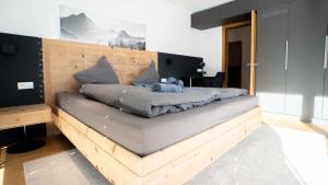 a bed with a teddy bear sitting on top of it at Großzügige Gartenwohnung mit Bergblick in Fritzens