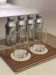 four empty wine glasses sitting on a wooden tray at Cava House - Vacation STAY 07286v in Tokyo