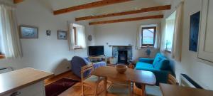 a living room with a blue couch and a table at Old School in Kingussie