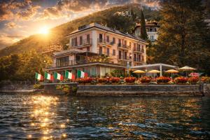a building on the side of a body of water at Hotel Meridiana in Bellano