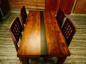 a wooden table with four chairs around it at Villa Stillrock in Dodanduwa +8 photos