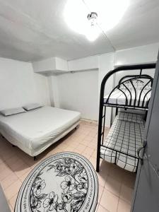 a bedroom with two bunk beds and a table at Resort safari hot spring in Calamba