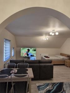a living room with a couch and a bed at Baza wypadowa 4 in Lubań