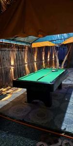 a green ping pong table in front of a tent at Resort safari hot spring in Calamba