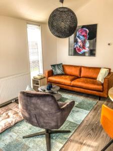a living room with a couch and a chair at Beachhouse in Hulshorst