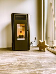 a black refrigerator with a candle in a room at Beachhouse in Hulshorst