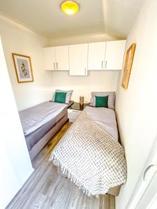 a small room with two beds and a rug at Beachhouse in Hulshorst