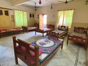 a room with several beds in a room at sandstone Villa jaisalmer in Jaisalmer