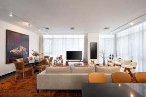 a living room with a couch and a dining room at Leonardo Boutique Hotel Tel Aviv in Tel Aviv