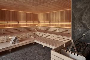 a sauna with wooden benches in a room at The Suites in St. Moritz