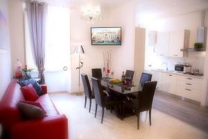 a living room with a dining room table and chairs at Luxury Domus Amadeus in Rome