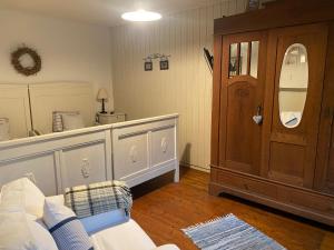 a living room with a couch and a mirror at Stern in Bergheim