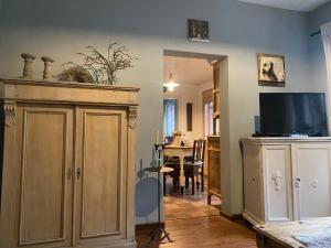 a living room with a tv and a large cabinet at Stern in Bergheim