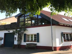 a white house with a green door and windows at Stern in Bergheim +6 photos