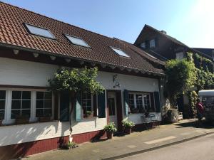 a white house with a red roof at Stern in Bergheim