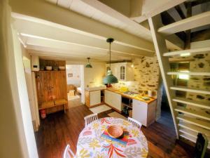 a kitchen with a table and a kitchen with a kitchen gmaxwell gmaxwell gmaxwell at Moulin de Boudelogne in Villard