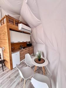 a room with a table and chairs in a tent at Forest glamp in Yasinya