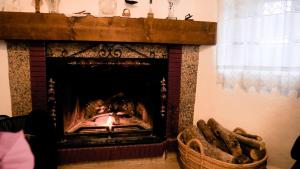 a fireplace in a living room with a fire place at Casa Rural Pilón Azul in Belerdas
