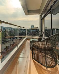 a balcony with two chairs and a view of the city at Atlantis Hotel Lagos in Lagos