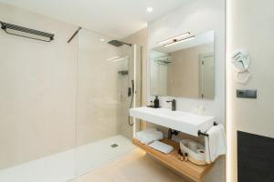 a bathroom with a sink and a shower at L'Agora Rooms in Bocairent +41 photos