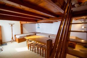 a room with a wooden table and a bed at Gîte Le Logis des Dieux in Sarrancolin