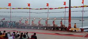 a group of people watching a performance on a boat at Varanasi Paying Guest House Assi Ghat in Varanasi