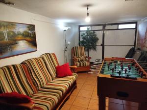 a living room with a couch and a chess board at Casa Los Lagares in Peral de Arlanza