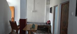 a room with a table and a table and a chair at Varanasi Paying Guest House Assi Ghat in Varanasi