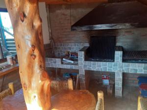 a room with a wooden table and a fireplace at Cabañas Bellavista del mar in De Cauquenes +8 photos
