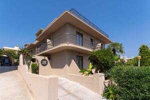 a house with a balcony on the side of it at Mariette Rhodes Urban Suites in Rhodes Town