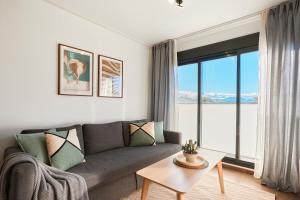a living room with a couch and a large window at Las Dunas 215 - by Welcomely in Oliva
