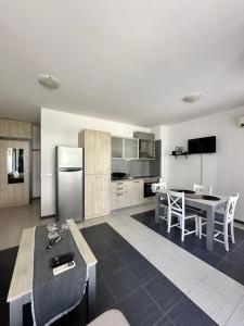 a kitchen and dining room with a table and refrigerator at Апартаменти Литорал in Chernomorets