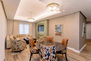 a living room with a table and a couch at Steyn City Hotel by Saxon in Midrand