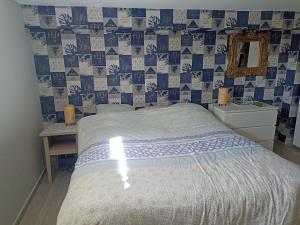 a small bedroom with a bed and a mirror at Chez Marianne in Hotton