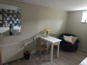 a small room with a table and a chair at Chez Marianne in Hotton
