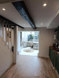 a kitchen with wooden floors and a large window at Village du Manémeur in Quiberon