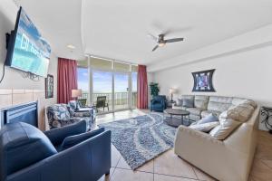 a living room with a couch and a tv at Turquoise Place 408C in Orange Beach